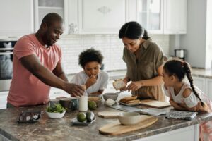 family around a kitchen table happy and cooking