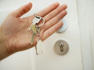 hand holding keys in front of door